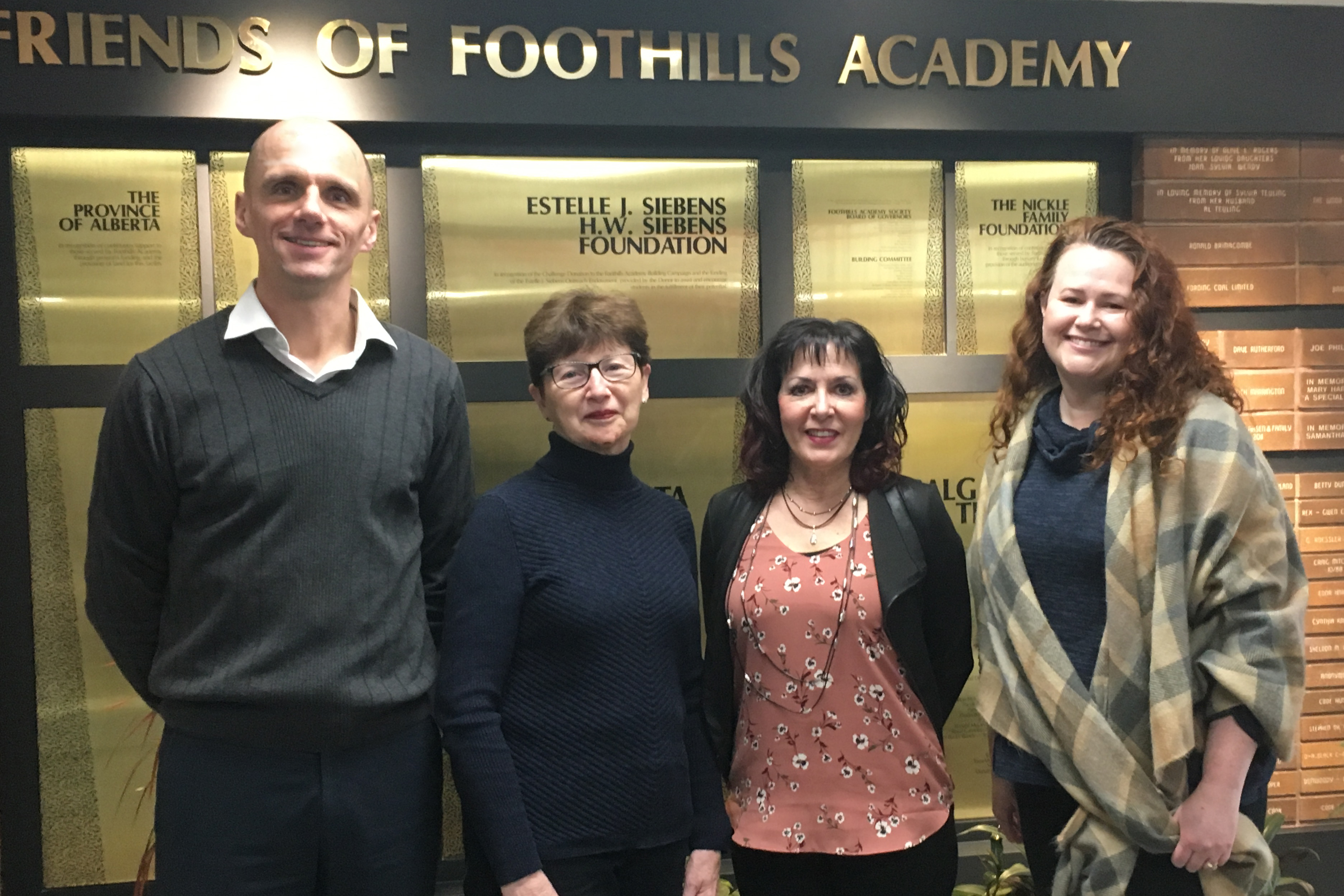 Foothills Academy staff accept donation from Rotary Club of Calgary South